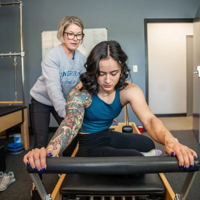 Coach Stacey leading a Pilates reformer session at Cornerstone Fitness