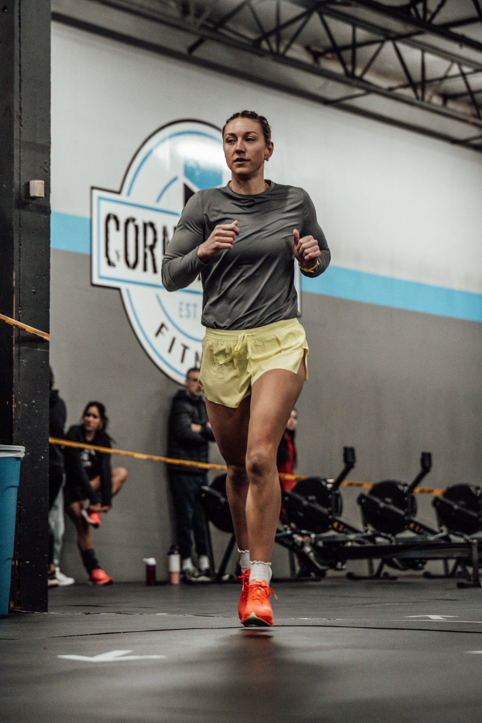 Coach spotting an athlete on the sled push